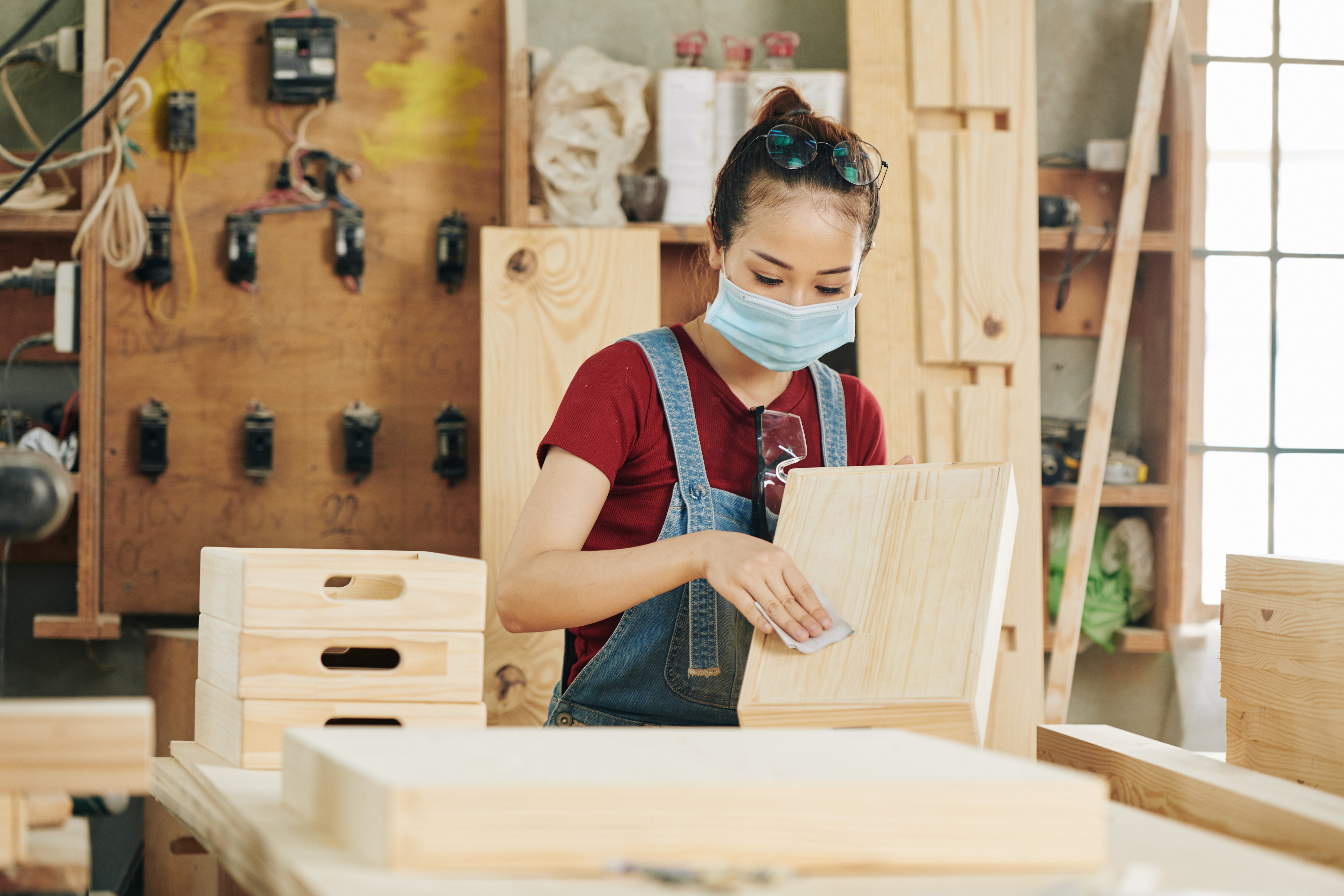 Carpenter sanding wooden drawer